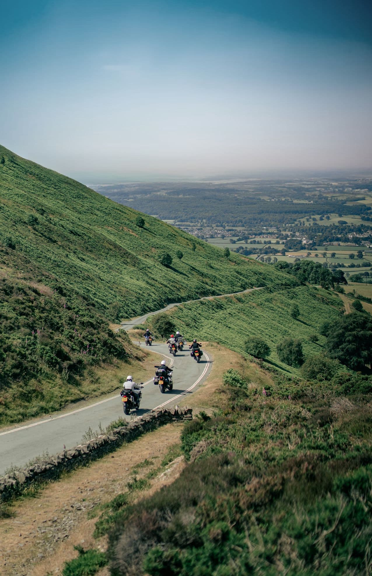 Motorcycles touring through scenic Welsh roads